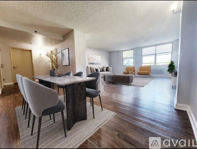 A living room with a dining table and chairs.