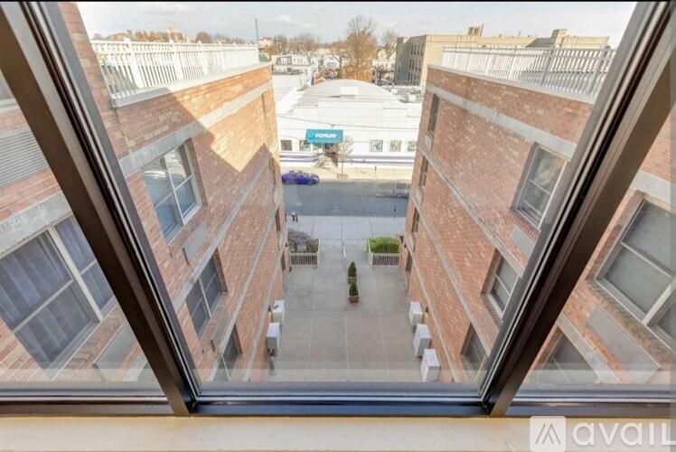 A view from a window of a courtyard between two buildings.