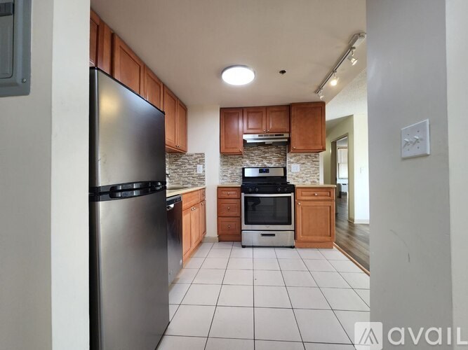 A kitchen with a refrigerator, oven, and microwave.