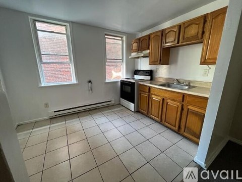 A kitchen with wooden cabinets and a black oven.