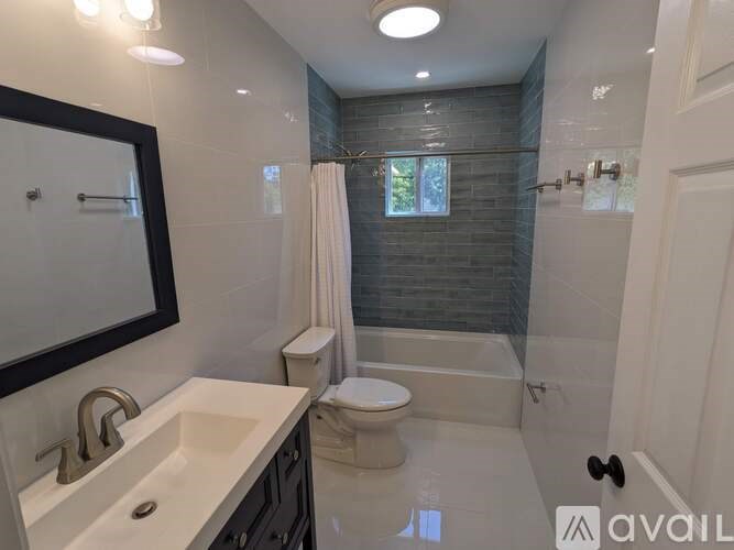 A bathroom with a toilet, sink, and bathtub.