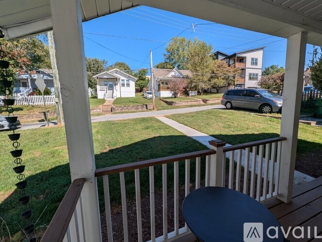 A view from a porch looking out at a residential neighborhood.