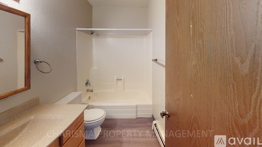 A bathroom with a toilet, sink, and bathtub.