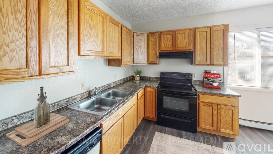 A kitchen with wooden cabinets and a black oven.