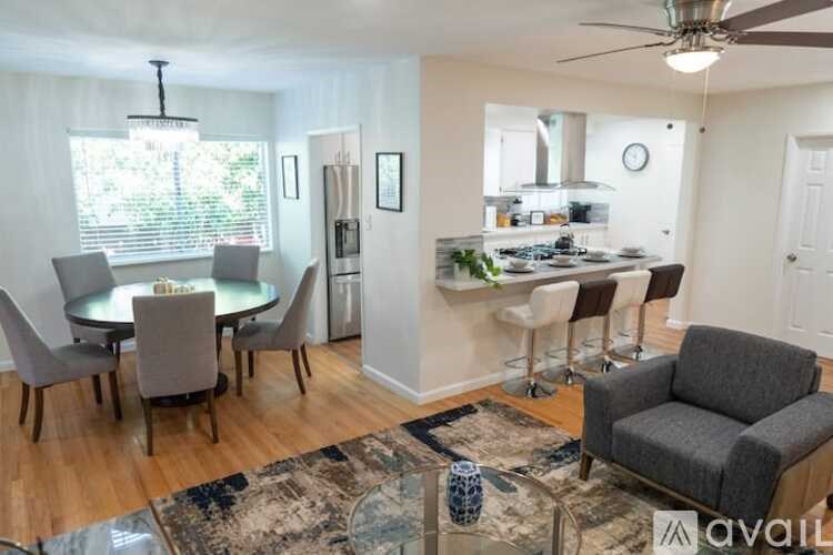 A living room with a dining table and chairs.
