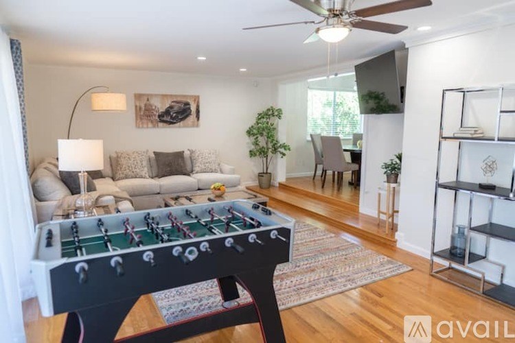 A foosball table is in the middle of a living room.