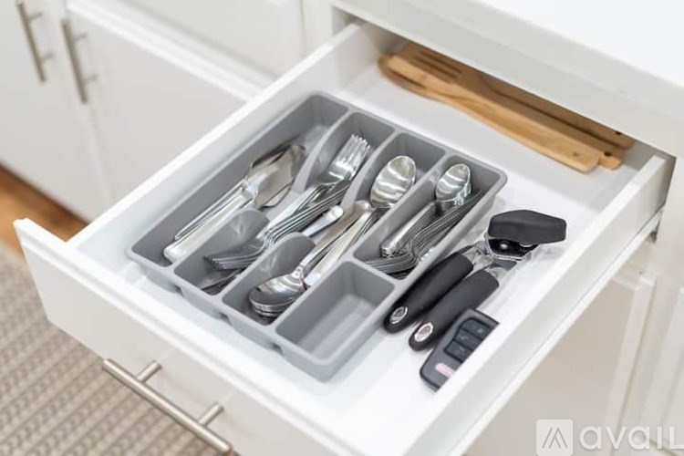 A drawer full of silverware and utensils.