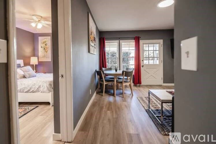 A bedroom with a bed, chair, and window.