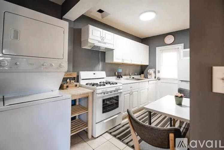 A kitchen with a white oven and a white fridge.