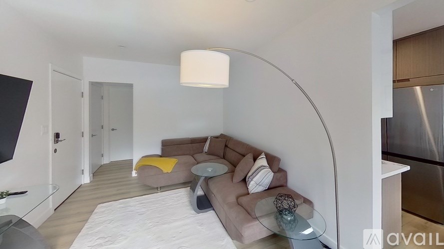 A modern living room with a curved wall and a sectional sofa.