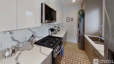 A kitchen with a marble countertop and a stove top oven.