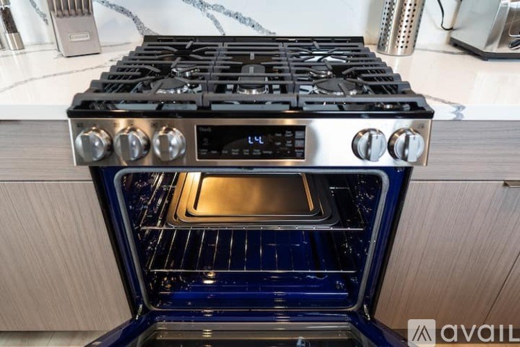 A modern stove top with a digital display and a blue oven.
