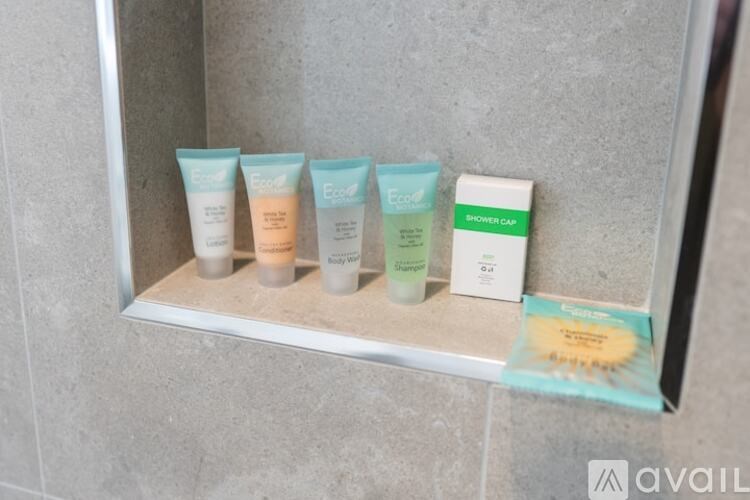 A display of skincare products including a moisturizer, a cleanser, and a toner.