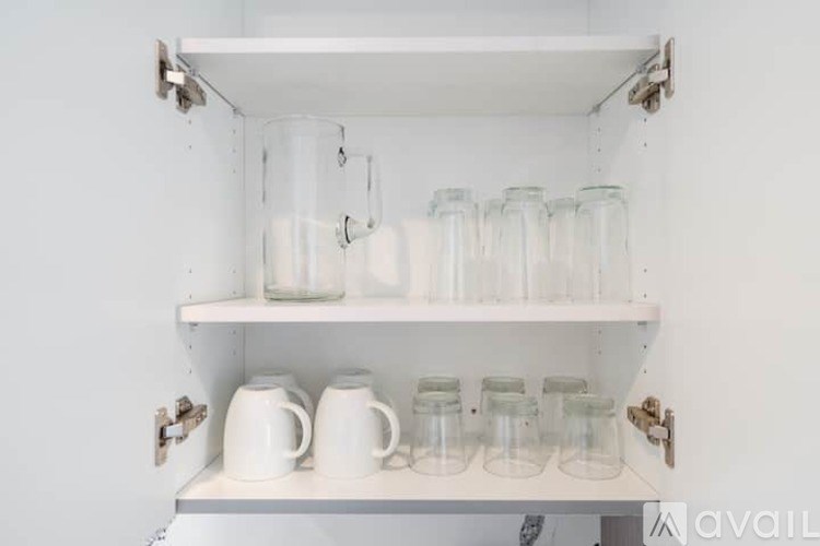 A shelf with glasses and cups on it.