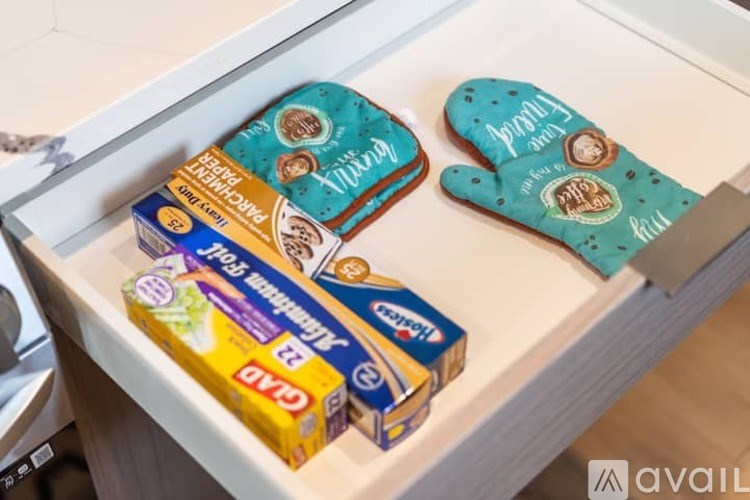 A box of tea and a box of biscuits are on a shelf.