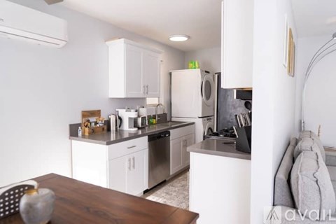 A kitchen with white cabinets and stainless steel appliances.