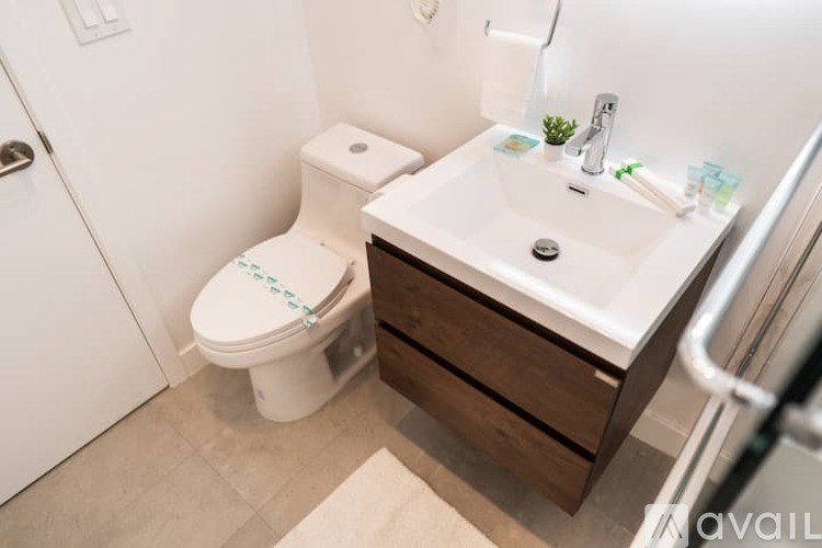 A white toilet is next to a sink in a bathroom.