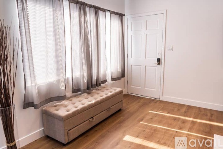 A room with a bench and a door.