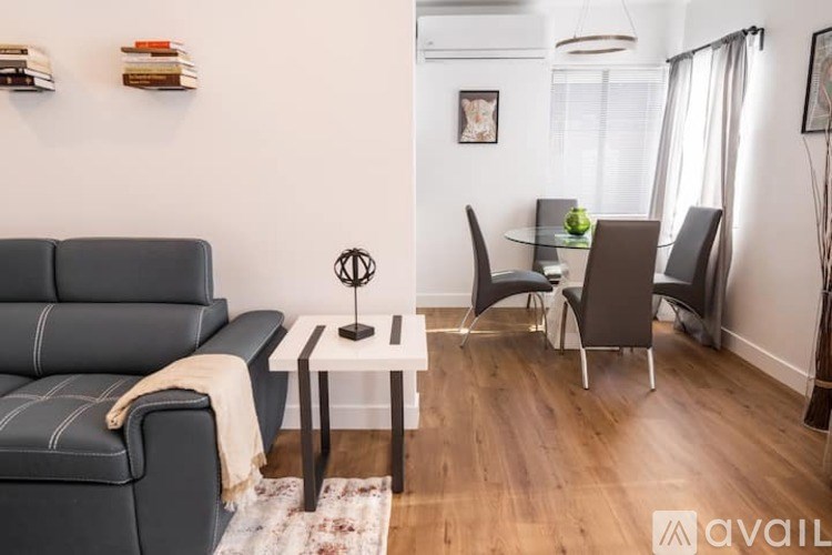 A living room with a grey sofa and a white coffee table.