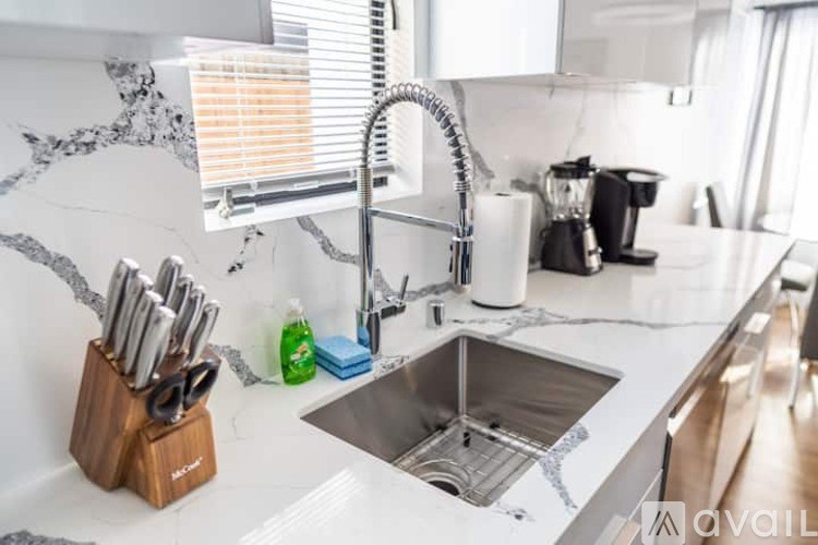 A kitchen with a sink and a knife block.