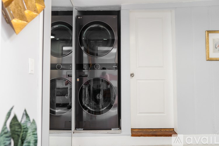 A washing machine is sitting in a small laundry room.