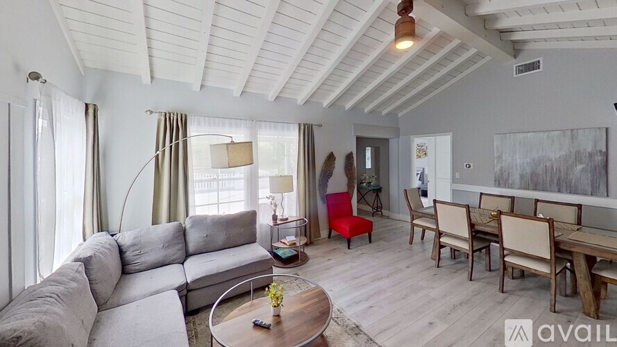 A living room with a grey sofa and a wooden coffee table.