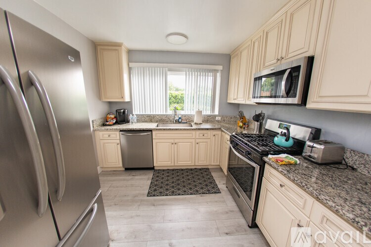 A kitchen with granite countertops and stainless steel appliances.