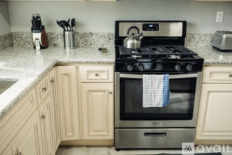 A kitchen with a stove and cabinets.