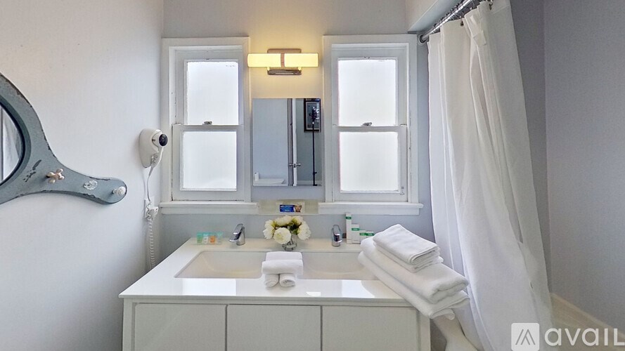 A bathroom with a sink, mirror, and towel rack.