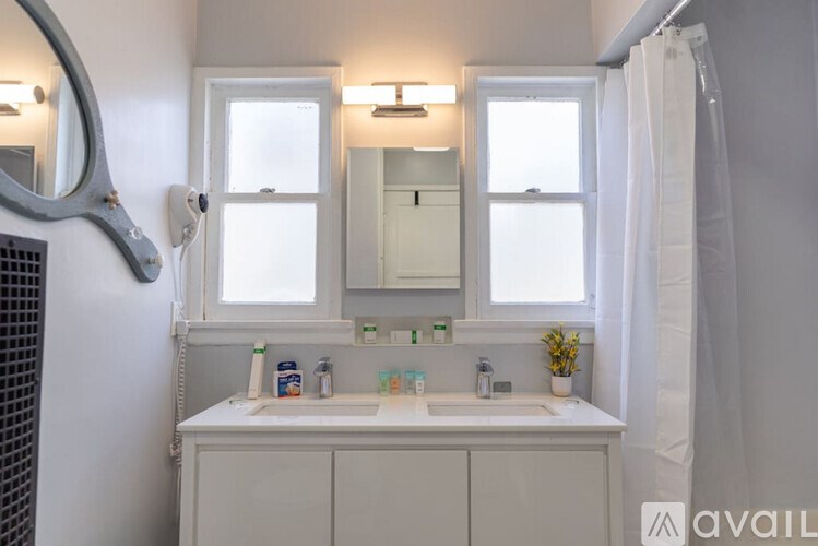 A bathroom with a white sink and a mirror above it.