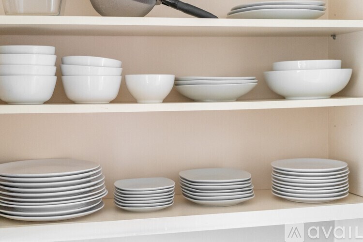 White dishes on a shelf.