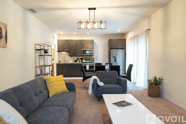 A modern living room with a grey sofa and a white coffee table.