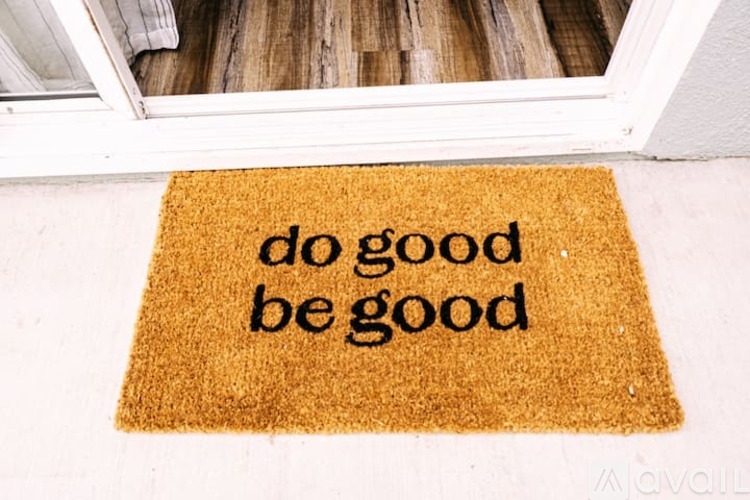 A doormat that says "do good be good".