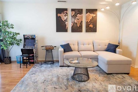 A living room with a white sofa and a black coffee table.