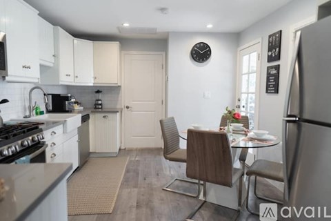 A kitchen with a table and chairs in the middle of the room.