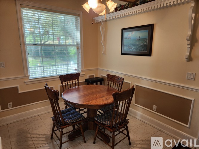 A dining room with a wooden table and chairs.