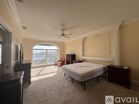 A bedroom with a bed, dresser, and television.