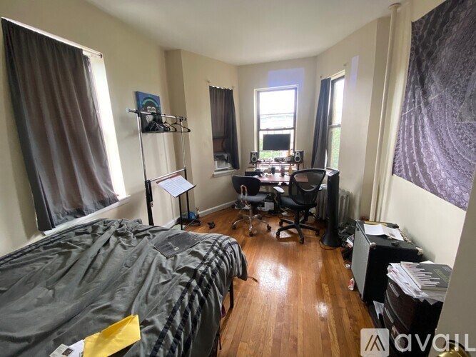 A room with a bed, desk, and chair.