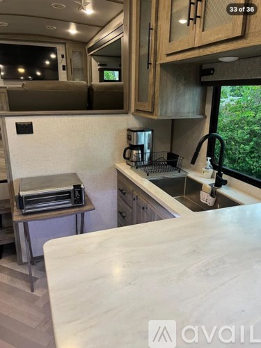 A kitchen area with a sink and a microwave.