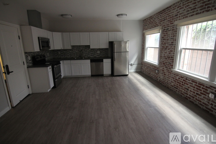 A kitchen with a refrigerator, microwave, and oven.