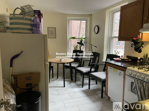 A kitchen with a table and chairs in the middle of the room.