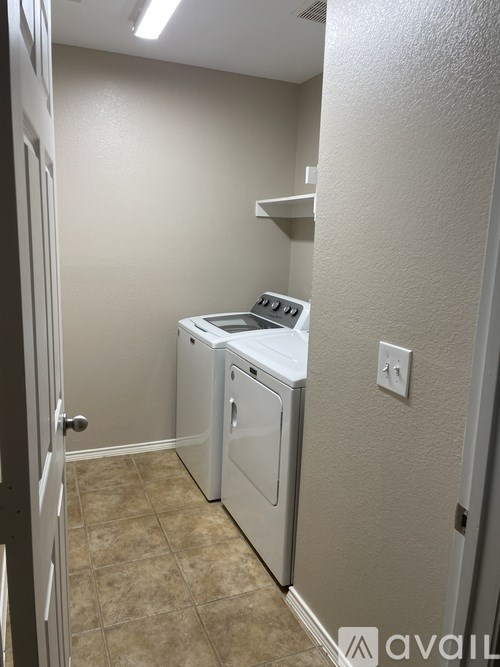 A small laundry room with a washer and dryer.
