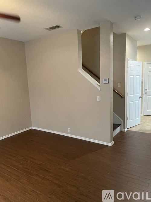 A room with wooden floors and a white door.
