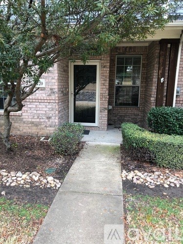 A house with a tree in front of it.