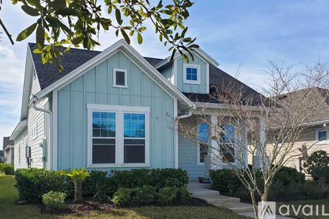 A blue house with a white trim and a small window on the front.