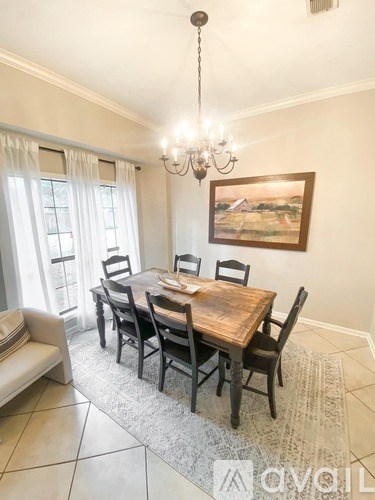 A dining room with a wooden table and chairs.