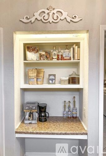 A shelf with a coffee maker and bottles on it.