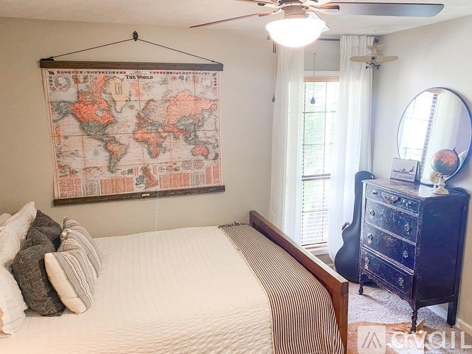 A bedroom with a world map on the wall.