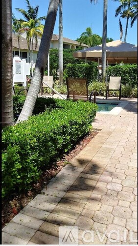 A walkway with a pool in the background.