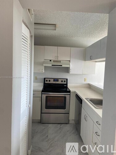 A kitchen with a stove top oven and a sink.